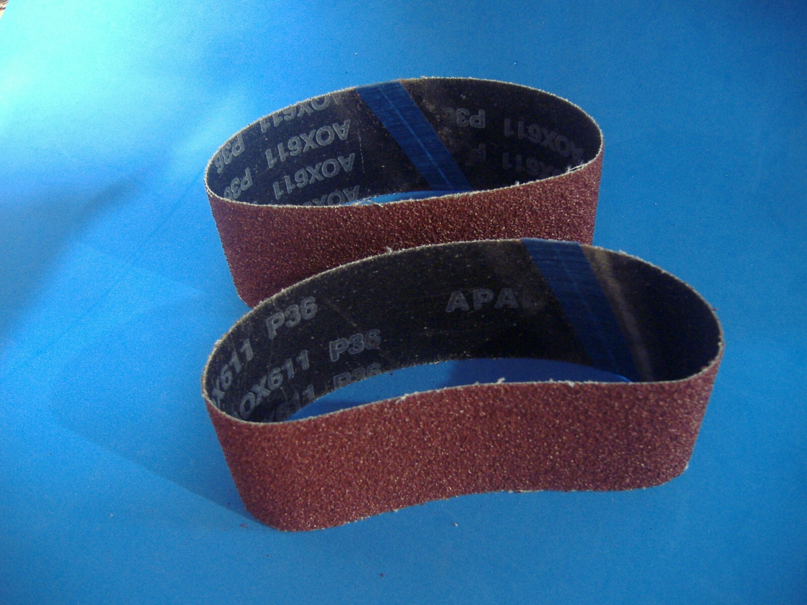 LOT OF TWO 2 1/2″ X 16″ ALUMINUM OXIDE SANDING BELTS 36 GRIT